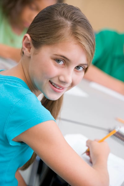 Fifth grader working through practice problems at her desk