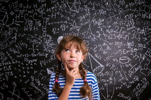 Second grader solving math problems at his desk