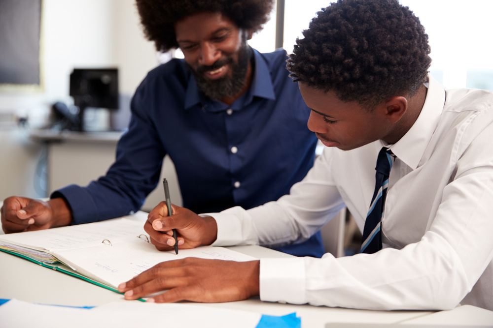 A tutor works one-on-one through math problems with a student