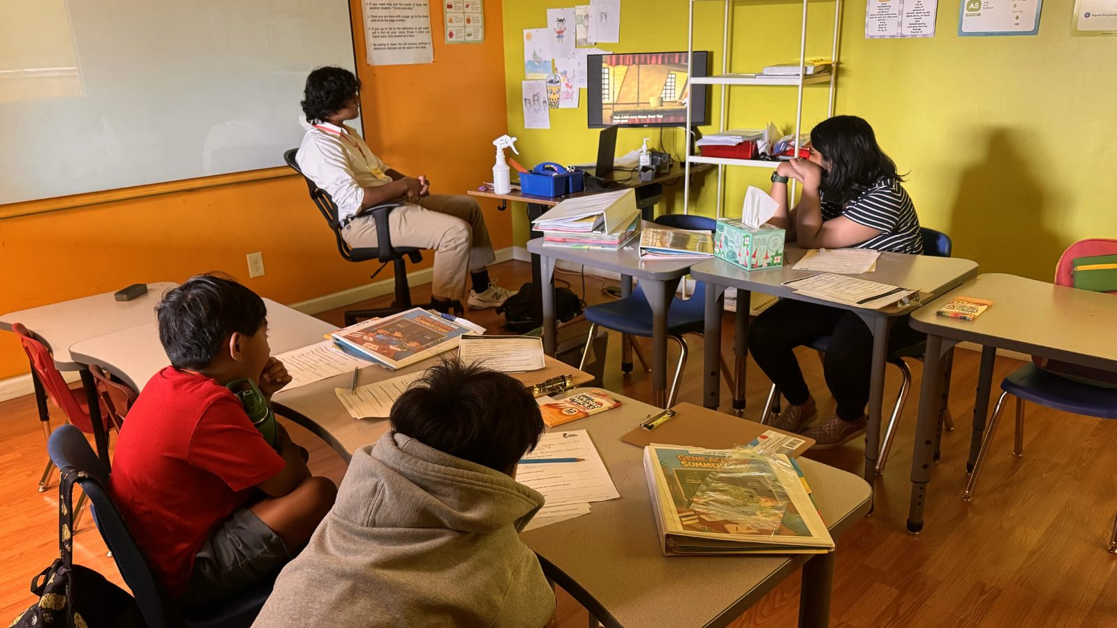Students working with their coach in a Genie Academy classroom