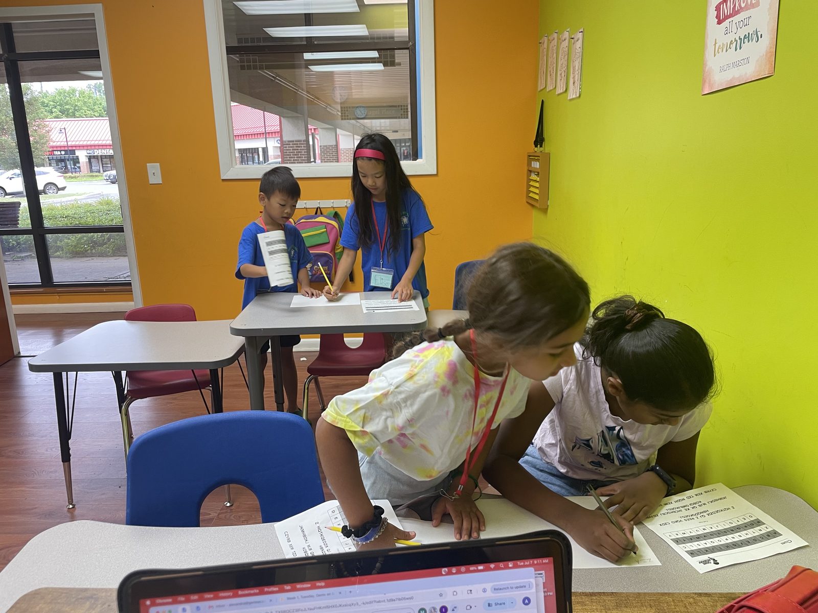 Campers compare notes and work together during a classroom mystery-solving activity