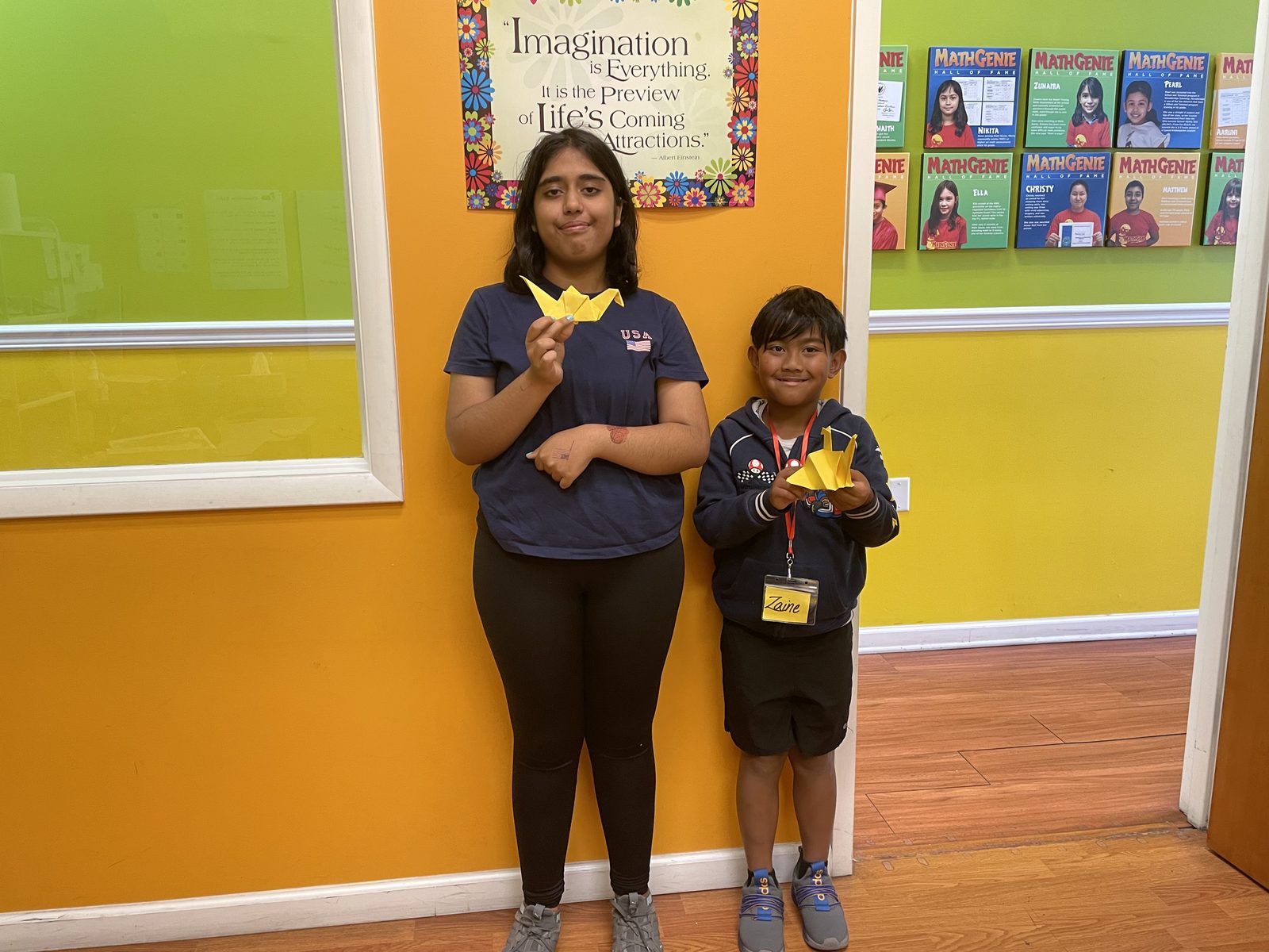 Two campers show off their finished paper origami creations